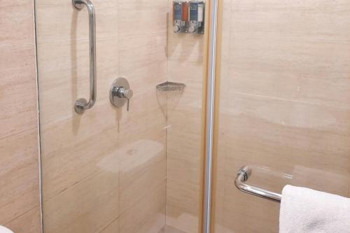 a shower with a glass door in a bathroom at Four Points by Sheraton Vadodara in Vadodara