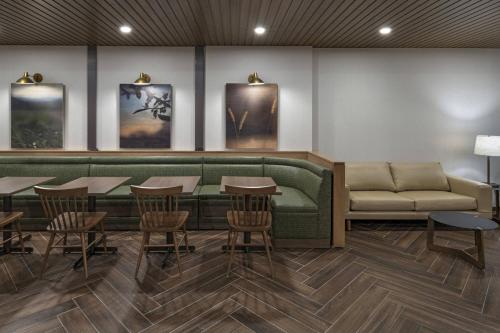 a restaurant with a couch and tables and chairs at Fairfield Inn and Suites by Marriott St Louis Downtown in Saint Louis