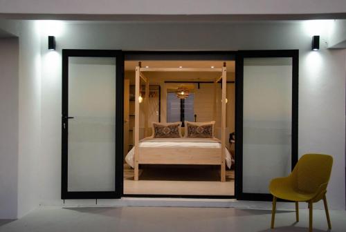 a bedroom with a bed through a glass door at Bella La Vita Beachfront Villa in Velddrif