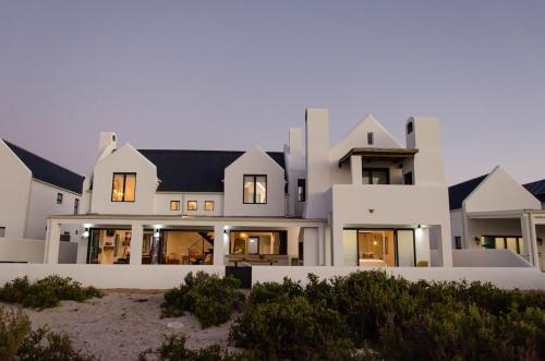 a large white house on the beach at Bella La Vita Beachfront Villa in Velddrif