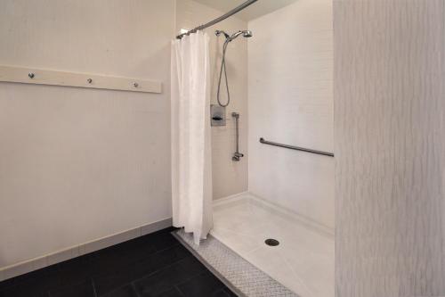 a bathroom with a shower with a shower curtain at Four Points Philadelphia City Center in Philadelphia