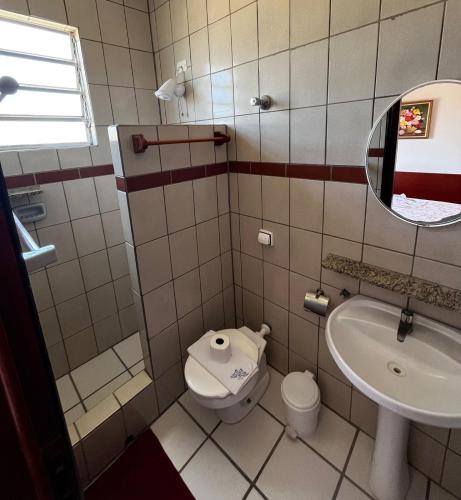 a small bathroom with a toilet and a sink at Pousada Weiss Blau in Ilha Comprida