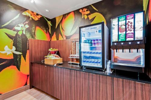 a drink counter in a restaurant with a colorful wall at Fairfield Inn & Suites by Marriott St Petersburg North in St Petersburg