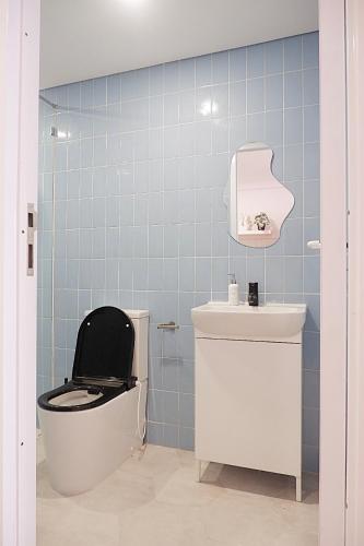 a bathroom with a toilet and a sink at Ponder Bali Canggu in Canggu