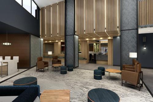 a lobby of a hotel with tables and chairs at Chicago Marriott Schaumburg in Schaumburg