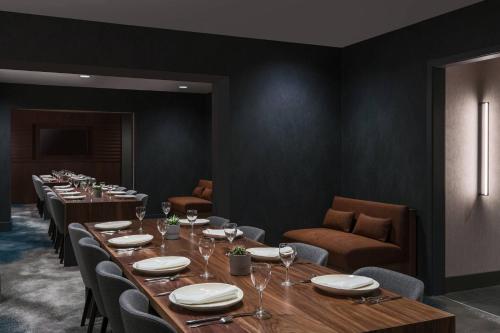a dining room with long tables and chairs at Chicago Marriott Schaumburg in Schaumburg