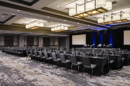 a conference room with rows of tables and chairs at Chicago Marriott Schaumburg in Schaumburg