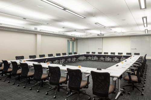 a large conference room with a long table and chairs at Four Points by Sheraton Norwood Conference Center in Norwood