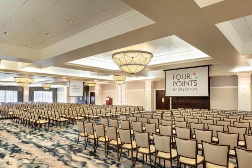a large room with rows of chairs and a sign at Four Points by Sheraton Norwood Conference Center in Norwood