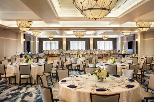a ballroom with tables and chairs in a ballroom at Four Points by Sheraton Norwood Conference Center in Norwood