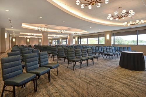a conference room with chairs and tables and windows at Four Points by Sheraton Boston Newton in Newton