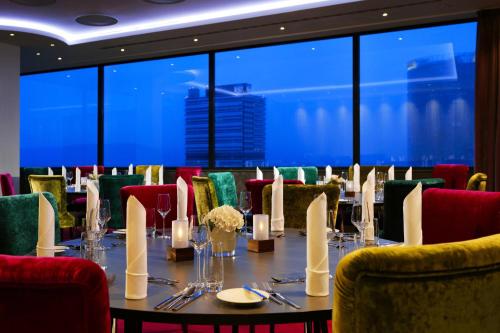 a dining room with a long table and chairs at Bonn Marriott Hotel in Bonn