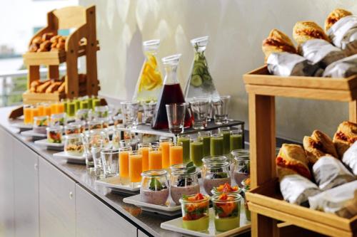 a buffet line with different types of food and drinks at Bonn Marriott Hotel in Bonn