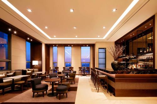 a restaurant with a bar and tables and chairs at Four Points by Sheraton Josun, Seoul Station in Seoul
