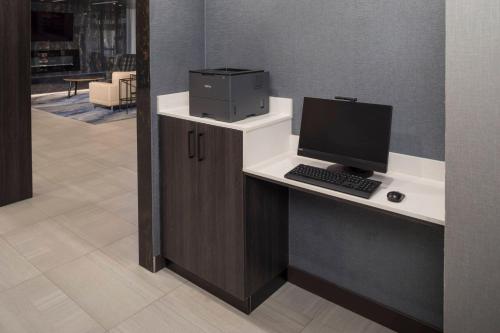 a desk with a computer on top of it at Fairfield Inn & Suites by Marriott Oklahoma City Downtown in Oklahoma City