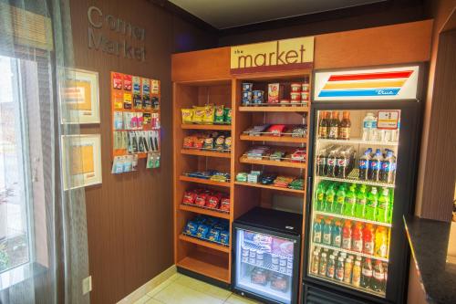 a grocery store aisle with a drink cooler and drinks at Fairfield Inn and Suites by Marriott Muskogee in Muskogee