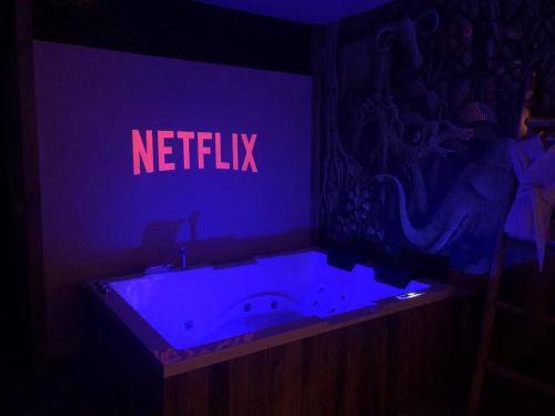a bathroom with a bath tub with a blue light at SPA La Casa Blue in Wingles