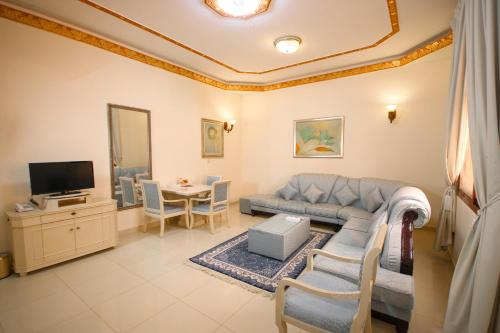 a living room with a couch and a table at Al Bada Hotel and Resort in Al Ain