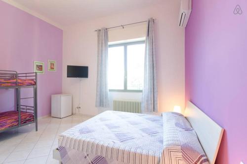 a bedroom with a large bed and a window at Casa Martina in Pescara