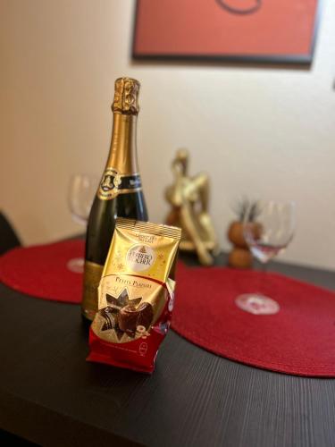 - une bouteille de champagne et une boîte de chocolat sur une table dans l'établissement Apartment Hyper Center Strasbourg & Petite France - Entire apartment, à Strasbourg