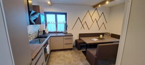a kitchen with a table and a dining room at Appartements Moser in Viehhofen