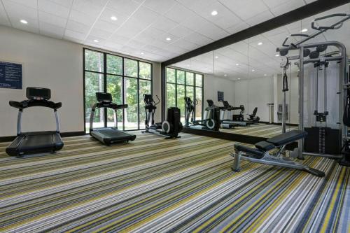 a gym with several treadmills and machines in a room at Four Points by Sheraton Birmingham Homewood in Homewood