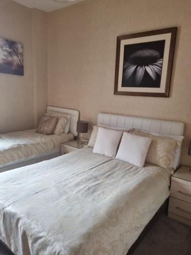 a bedroom with a large bed and a couch at The Sands Hotel in Paignton