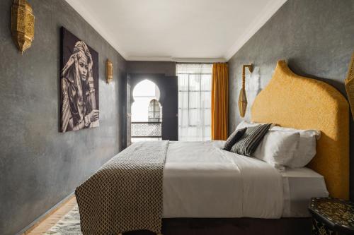 a bedroom with a large bed and a window at Riad Dar Acsameda & Spa in Marrakech