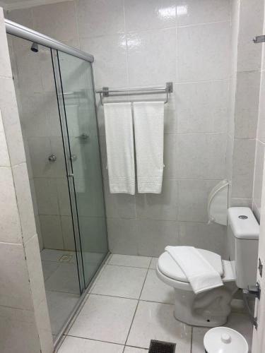 a bathroom with a glass shower and a toilet at City Hotel- Mercado Publico, Prefeitura Municipal in Porto Alegre