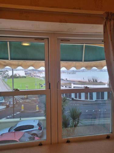 a window with a view of a parking lot at The Sands Hotel in Paignton