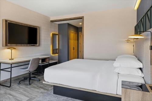 a hotel room with a bed and a desk at Courtyard by Marriott San Jose Escazu in San José