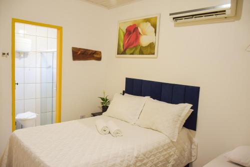 a bedroom with a bed with two slippers on it at Pousada Canto dos Pássaros in Lençóis