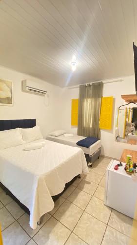 a large bedroom with two beds and a window at Pousada Canto dos Pássaros in Lençóis