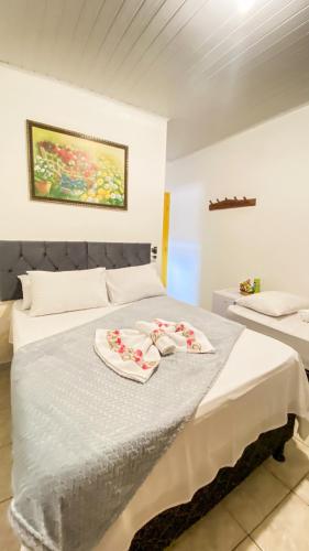 a bedroom with a bed with two towels on it at Pousada Canto dos Pássaros in Lençóis