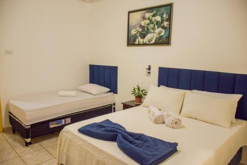 a bedroom with two beds with towels on it at Pousada Canto dos Pássaros in Lençóis
