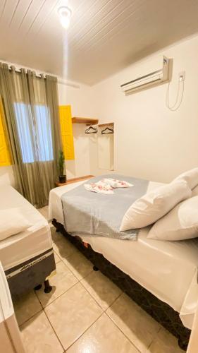 a bedroom with two beds and a window at Pousada Canto dos Pássaros in Lençóis