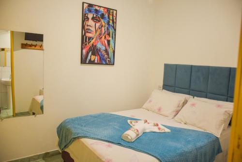 a bedroom with a bed with a doll on it at Pousada Canto dos Pássaros in Lençóis