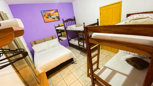 a room with a bunch of bunk beds in it at Pousada Canto dos Pássaros in Lençóis