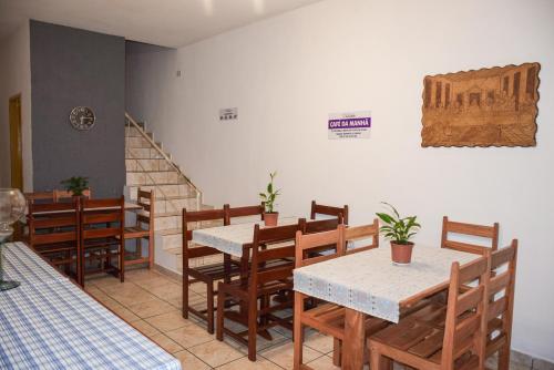 a restaurant with wooden tables and chairs and stairs at Pousada Canto dos Pássaros in Lençóis