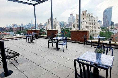 a patio with tables and chairs and a view of a city at Fairfield Inn & Suites By Marriott New York Brooklyn in Brooklyn