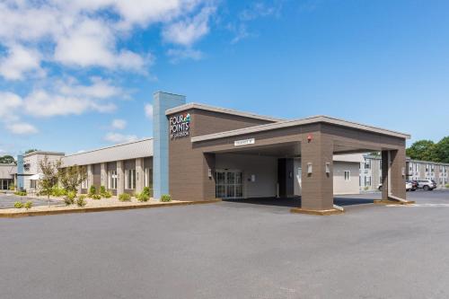 a store front of a building with a parking lot at Four Points by Sheraton Eastham Cape Cod in Eastham