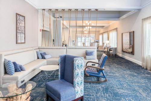 a living room with a couch and chairs at Four Points by Sheraton Eastham Cape Cod in Eastham