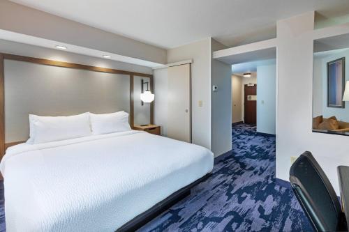 a large white bed in a hotel room at Fairfield Inn & Suites Tulsa Downtown Arts District in Tulsa