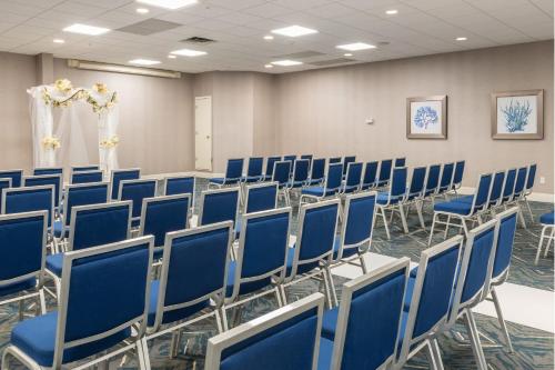 a room with blue chairs in a room at Four Points by Sheraton Eastham Cape Cod in Eastham