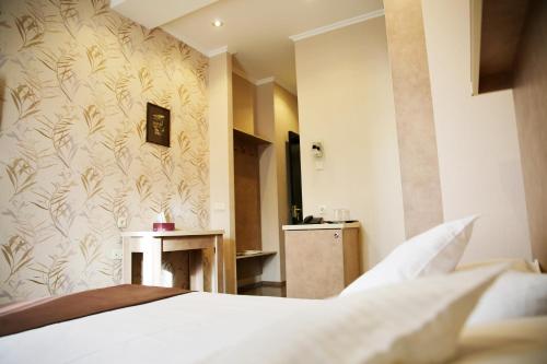 Postel nebo postele na pokoji v ubytování Rondo Hotel