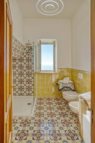 a bathroom with two toilets and a shower at Rosy's Room in Furore