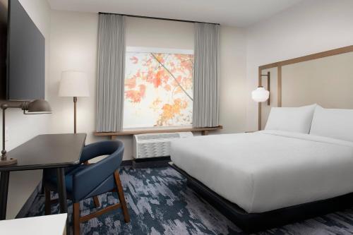 a hotel room with a bed and a desk and a window at Fairfield Inn & Suites by Marriott Santa Rosa Rohnert Park in Rohnert Park