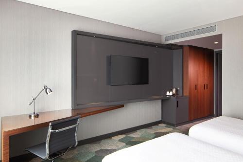 a hotel room with a flat screen tv and a desk at Four Points by Sheraton Istanbul Kagithane in Istanbul