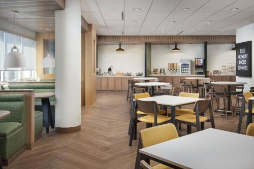 a restaurant with tables and chairs and a counter at Fairfield Inn & Suites by Marriott Santa Rosa Rohnert Park in Rohnert Park