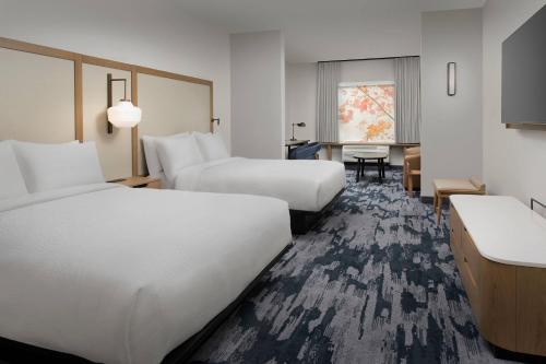 a hotel room with two beds and a desk at Fairfield Inn & Suites by Marriott Santa Rosa Rohnert Park in Rohnert Park